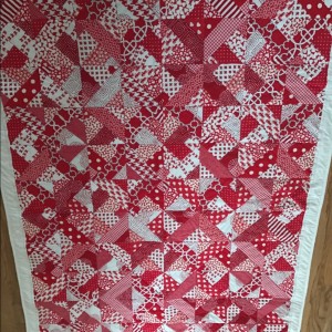Red and white lap quilt